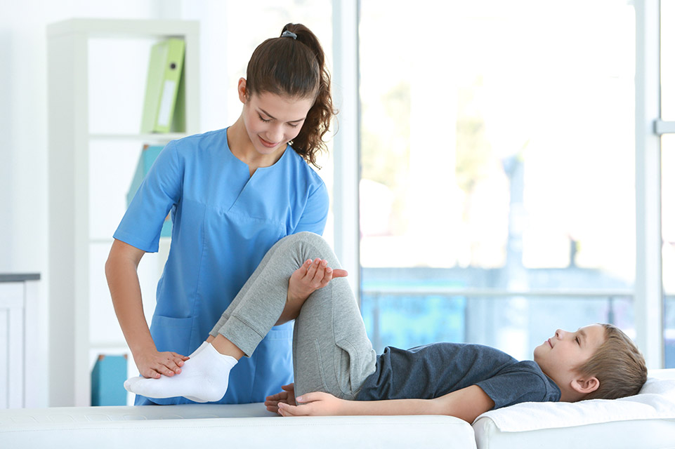 physician examines male patient knees