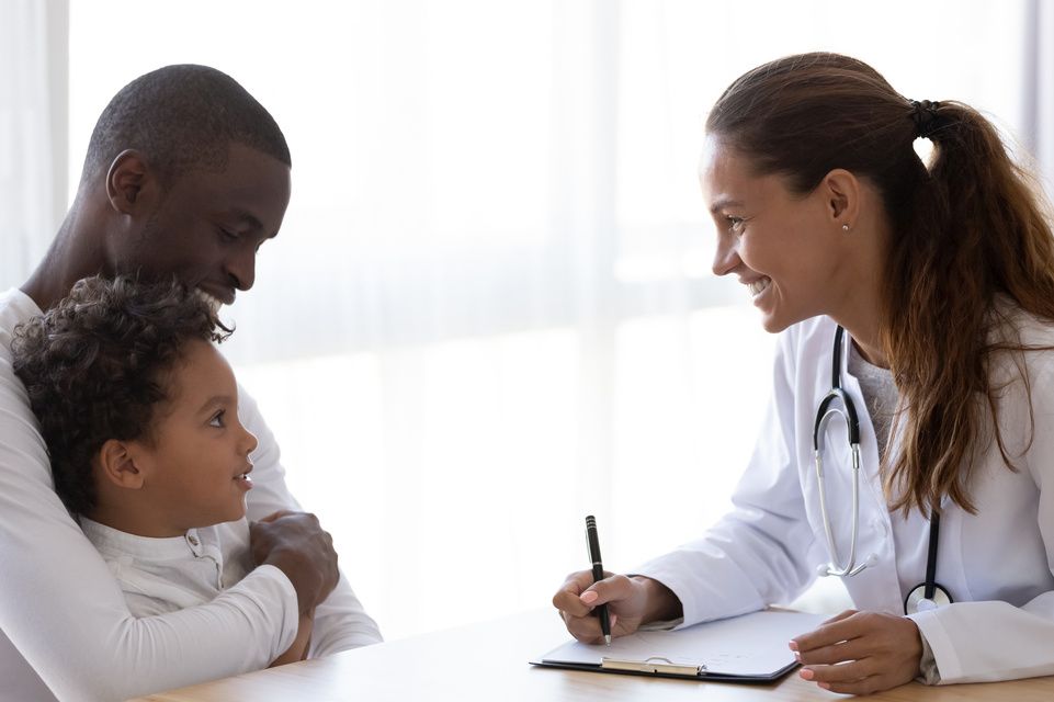 father and son talking to physician