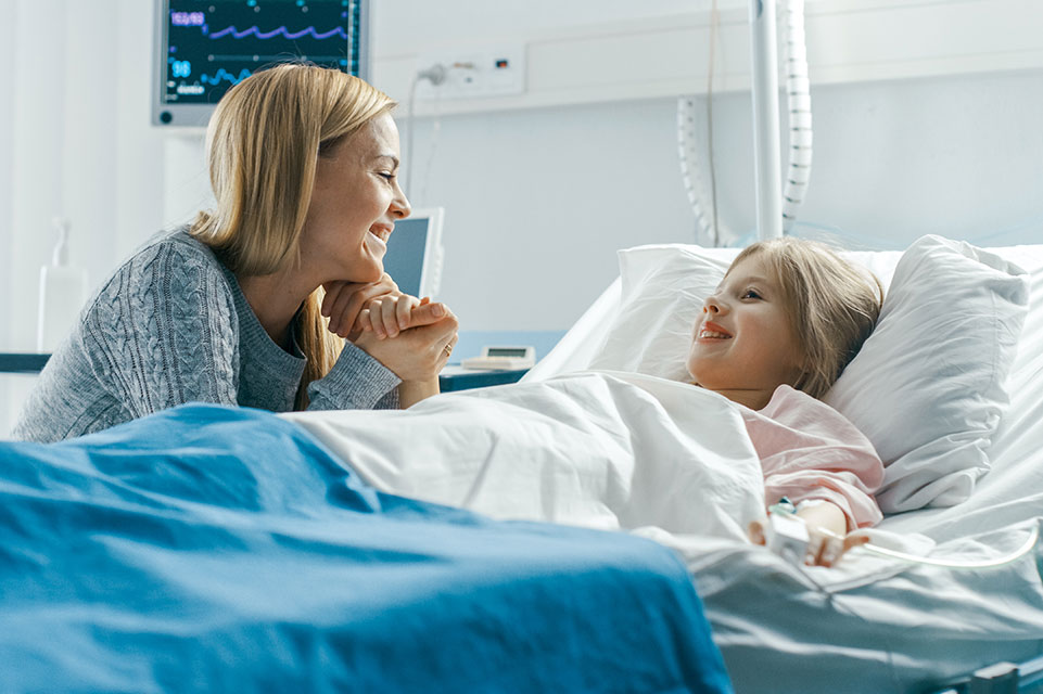 female patient in bed, mother visiting her