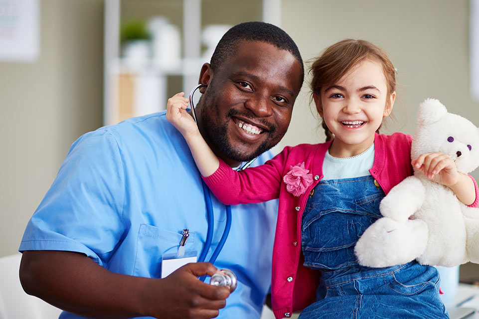 female patient holding teddy bear and physician