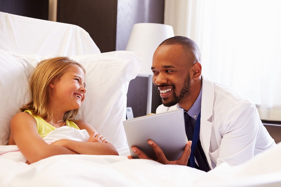 physician showing information on tablet to female patient