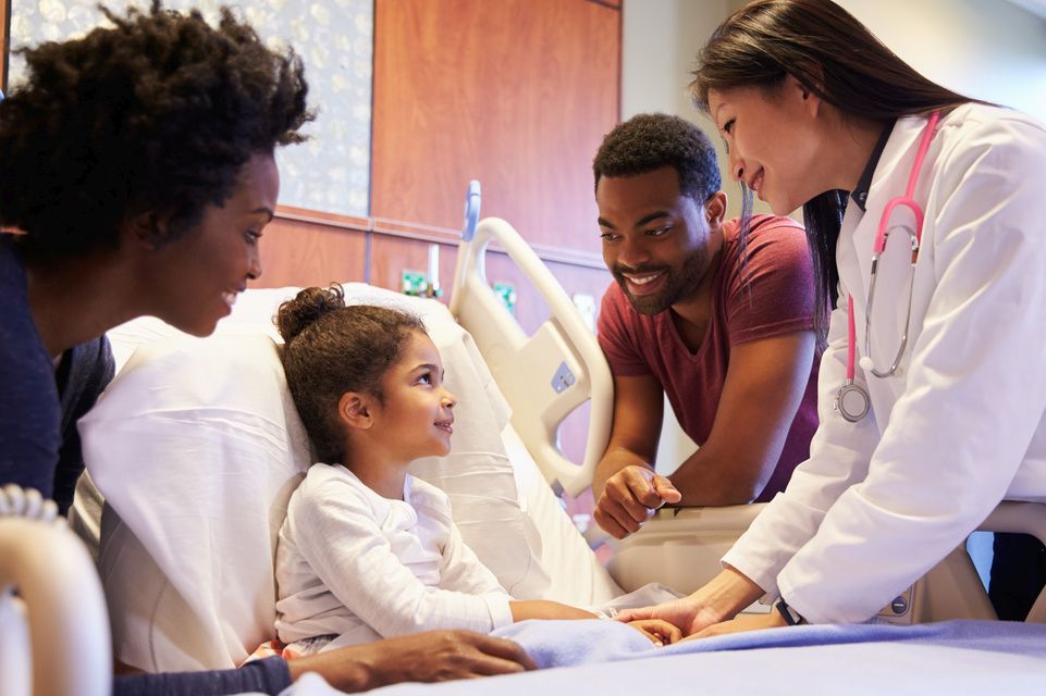 patient in hospital bed, mom dad and physician