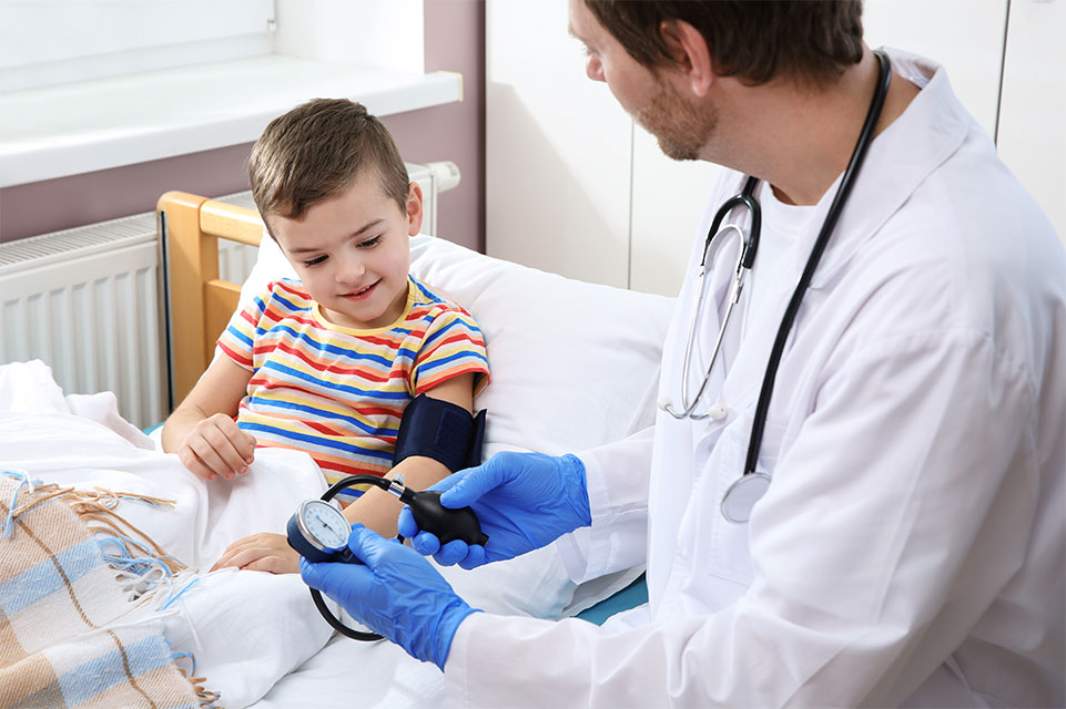 physician taking blood pressure of male patient