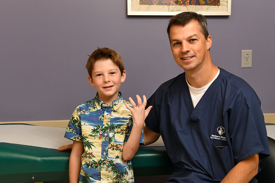 physician and male patient showing off his hand