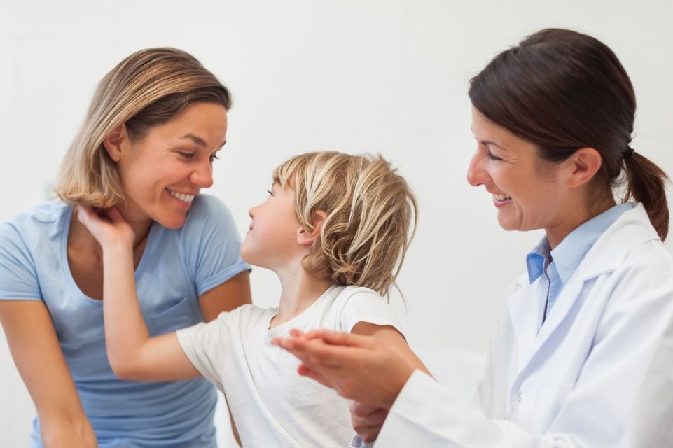 physician examines patient, mother looks on