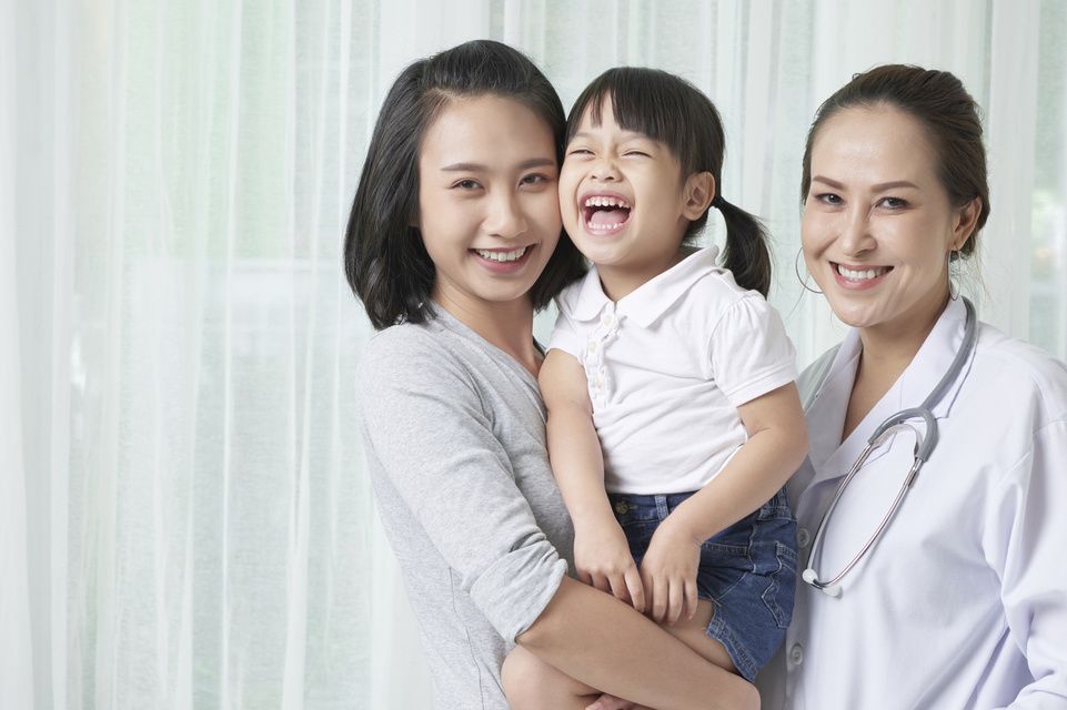 physician, mother holding daughter