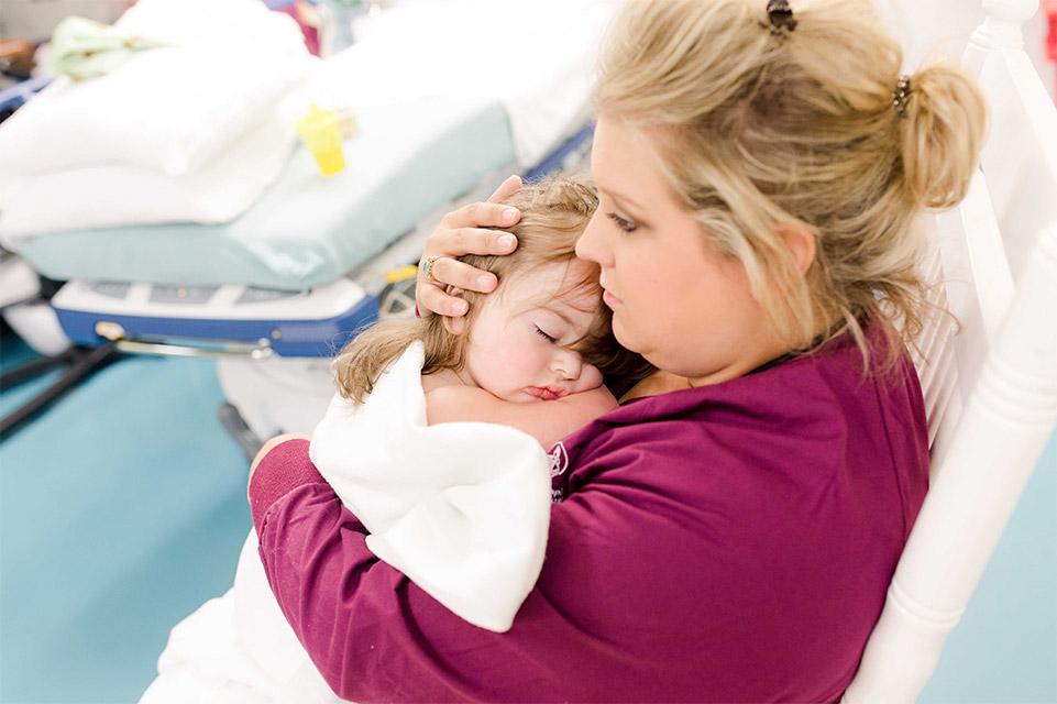 nurse holding sleeping patient