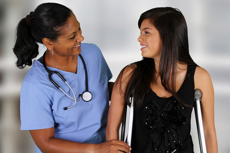 nurse assisting patient on crutches