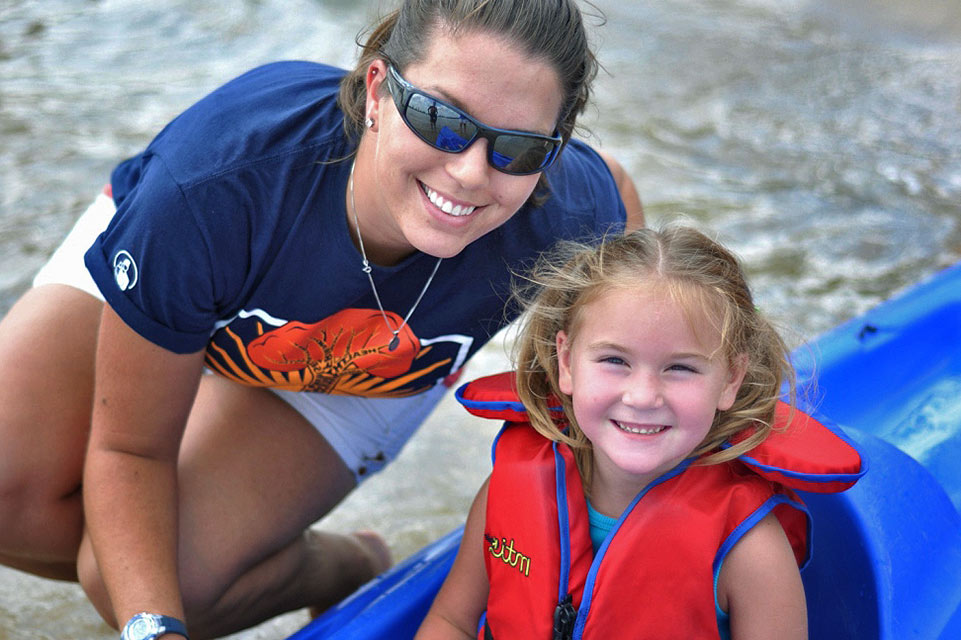 patient in boat with counselor at camp