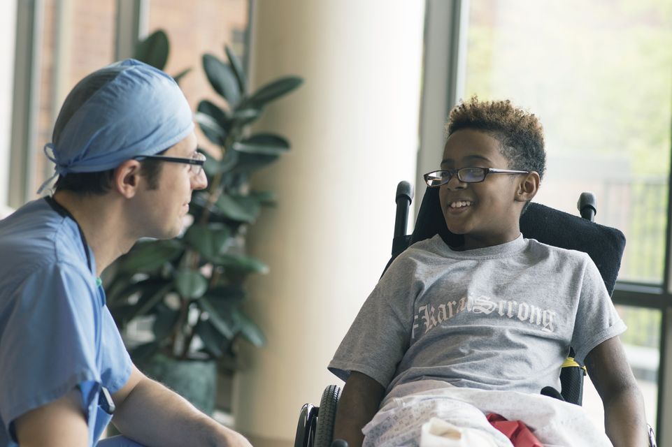 patient in wheelchair speaking with physician