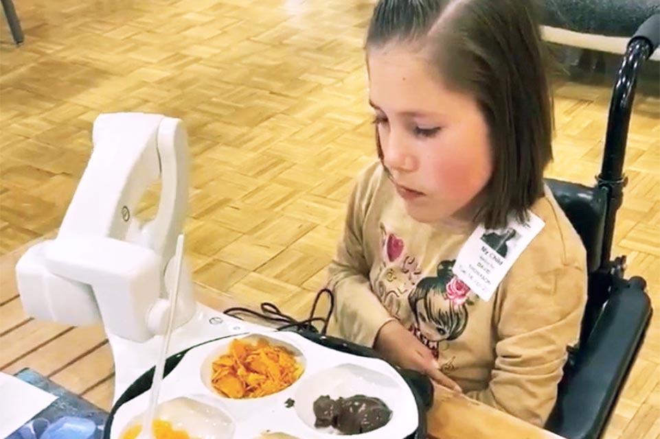 patient using machine to assist feeding