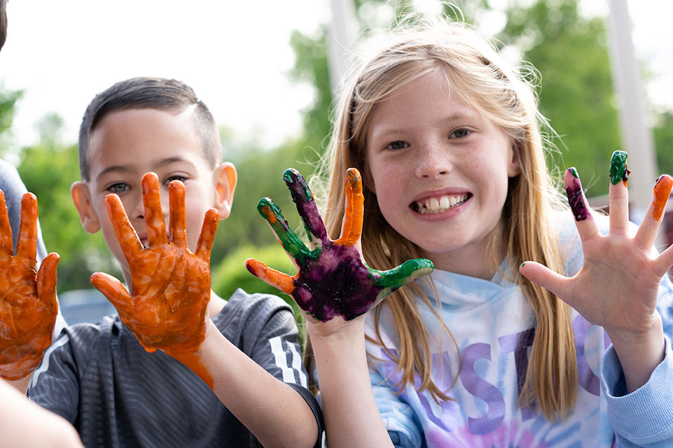 male and female patients displaying paint covered hands