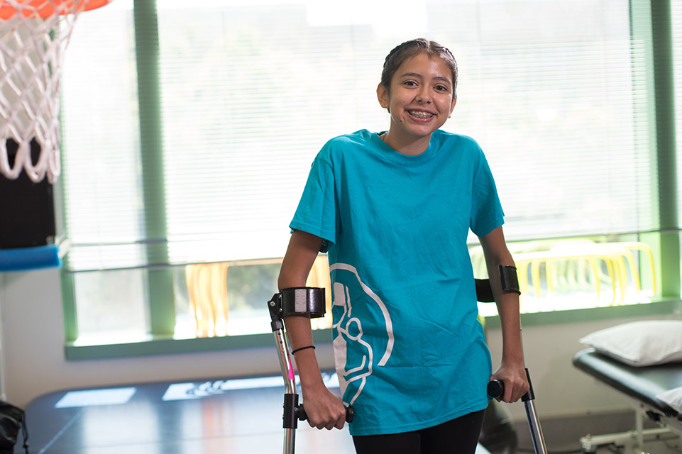 patient with crutches in gym