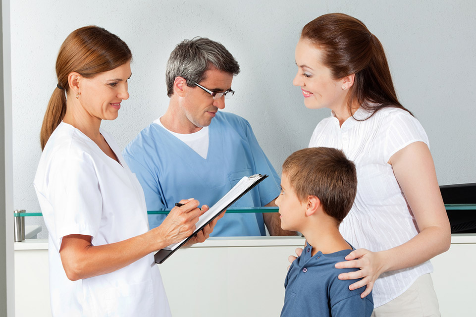 patient and mother with two providers