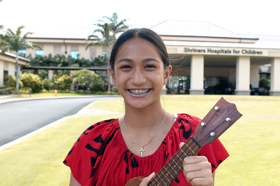 female patient holding ukelele