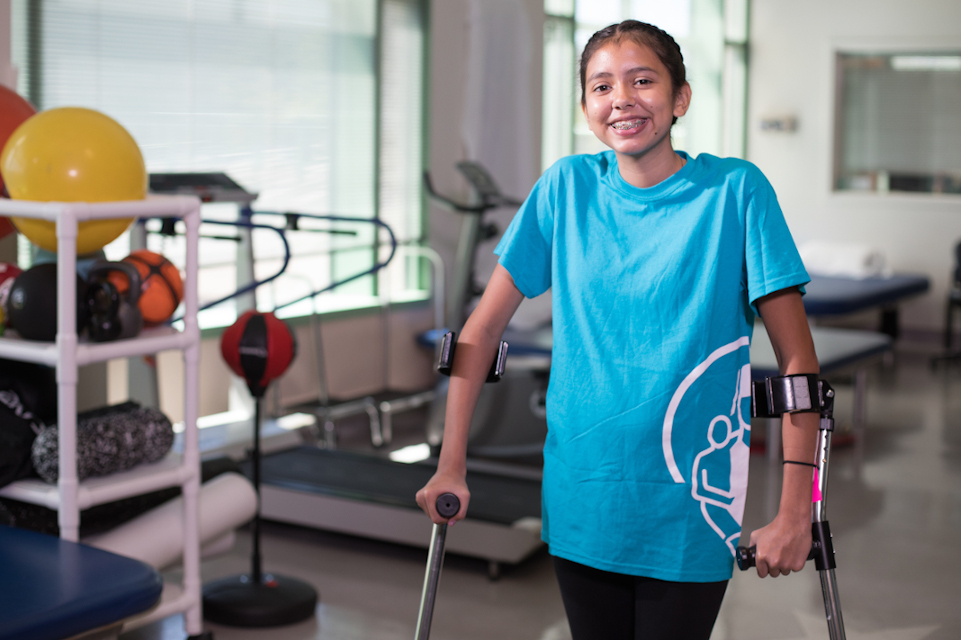 patient with back pain and back injury using crutches