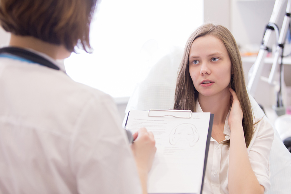 physician speaking with adolescent female patient