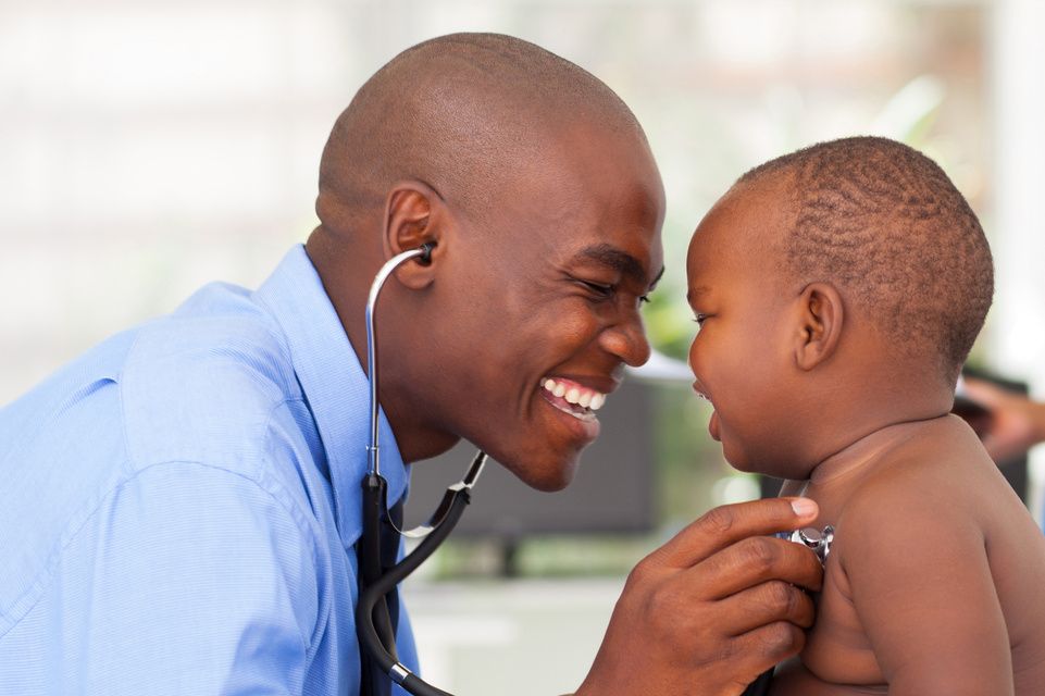 physician examines baby with stethoscope