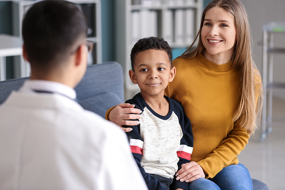 mother and son speaking with physician