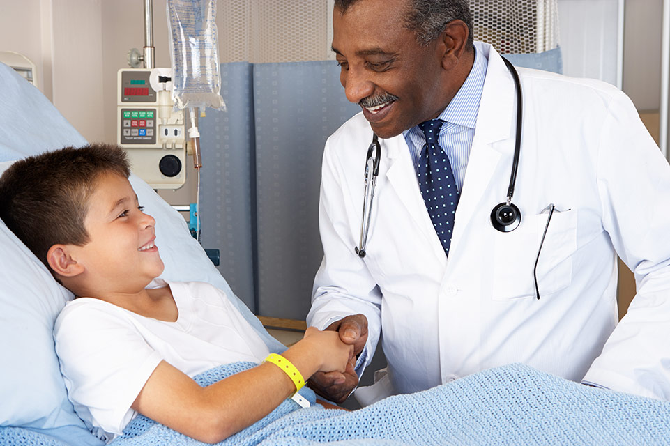 patient in hospital bed, physician speaking with him