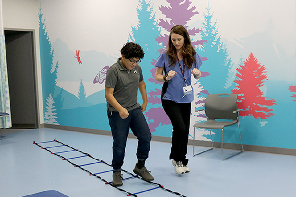 Patient and staff walking in a rehabilitation center.