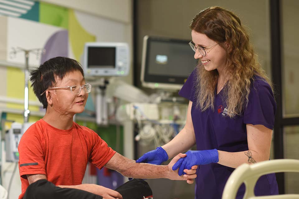 Nurse at male patient's bedside