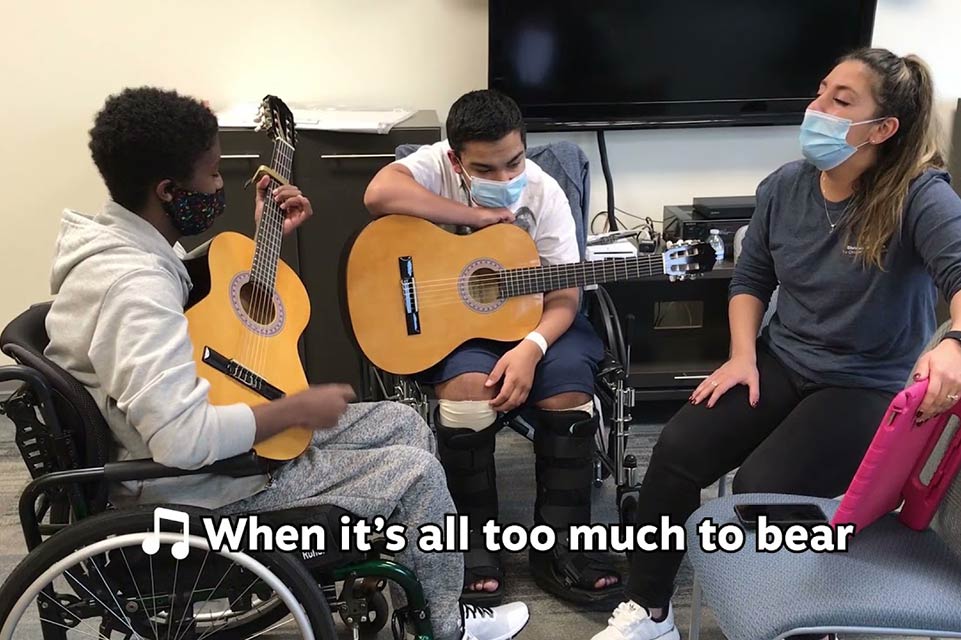 Robi, music therapist and another patient during musical therapy